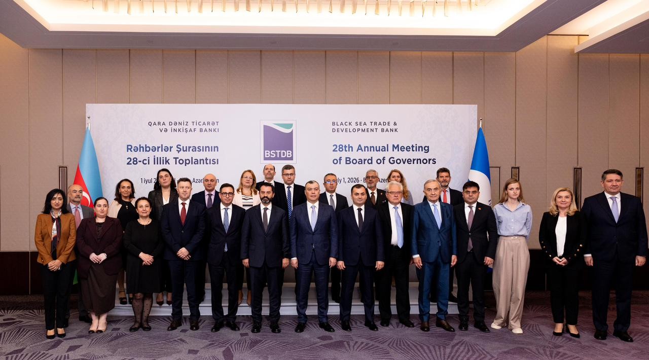 Group photo of participants at the BSTDB’s 28th Annual Meeting of the Board of Governors, posing in front of the event backdrop and the flags of Azerbaijan and BSTDB.
