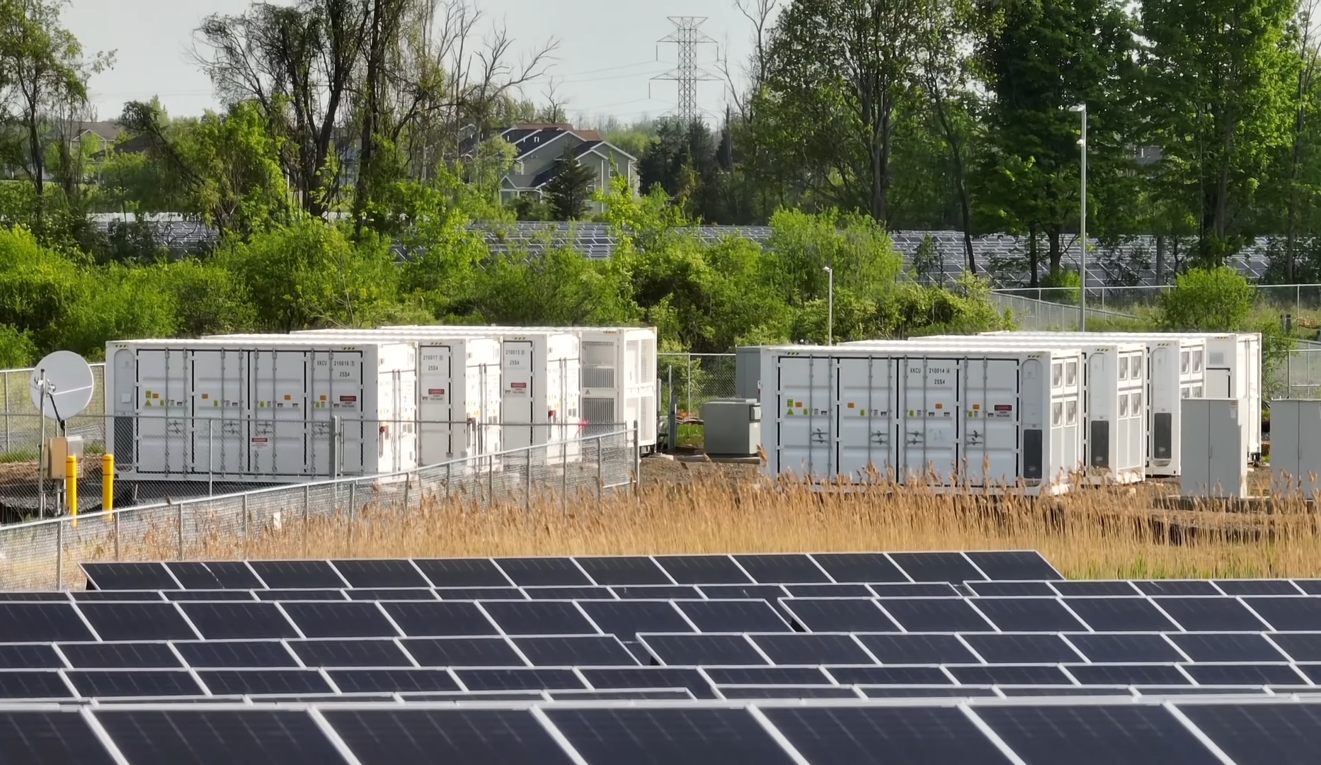Solar panels and battery energy storage units at a renewable energy facility.