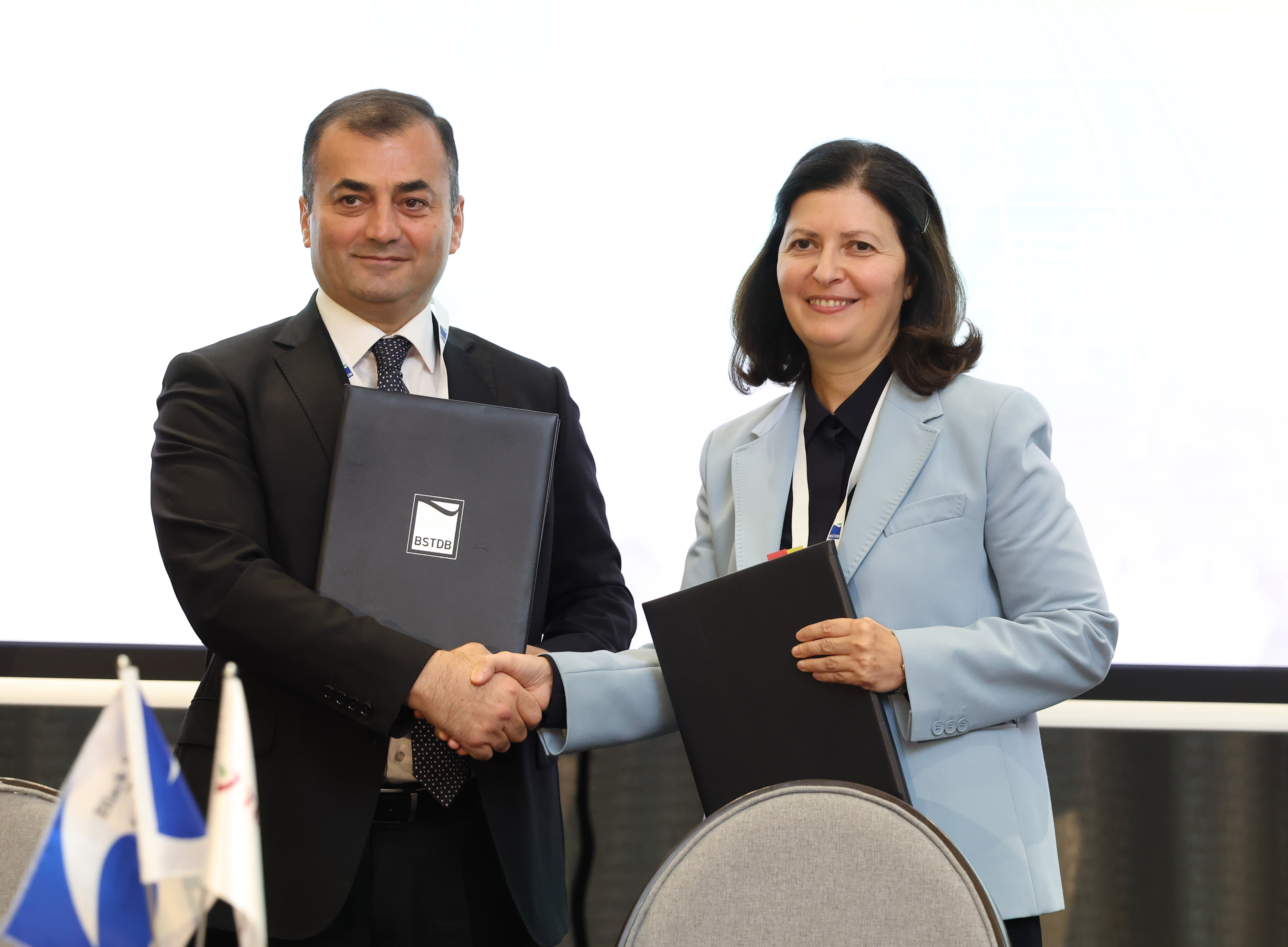 BSTDB and Terabank representatives shake hands and hold the signed agreement following the EUR 5 million financing ceremony in Tbilisi.